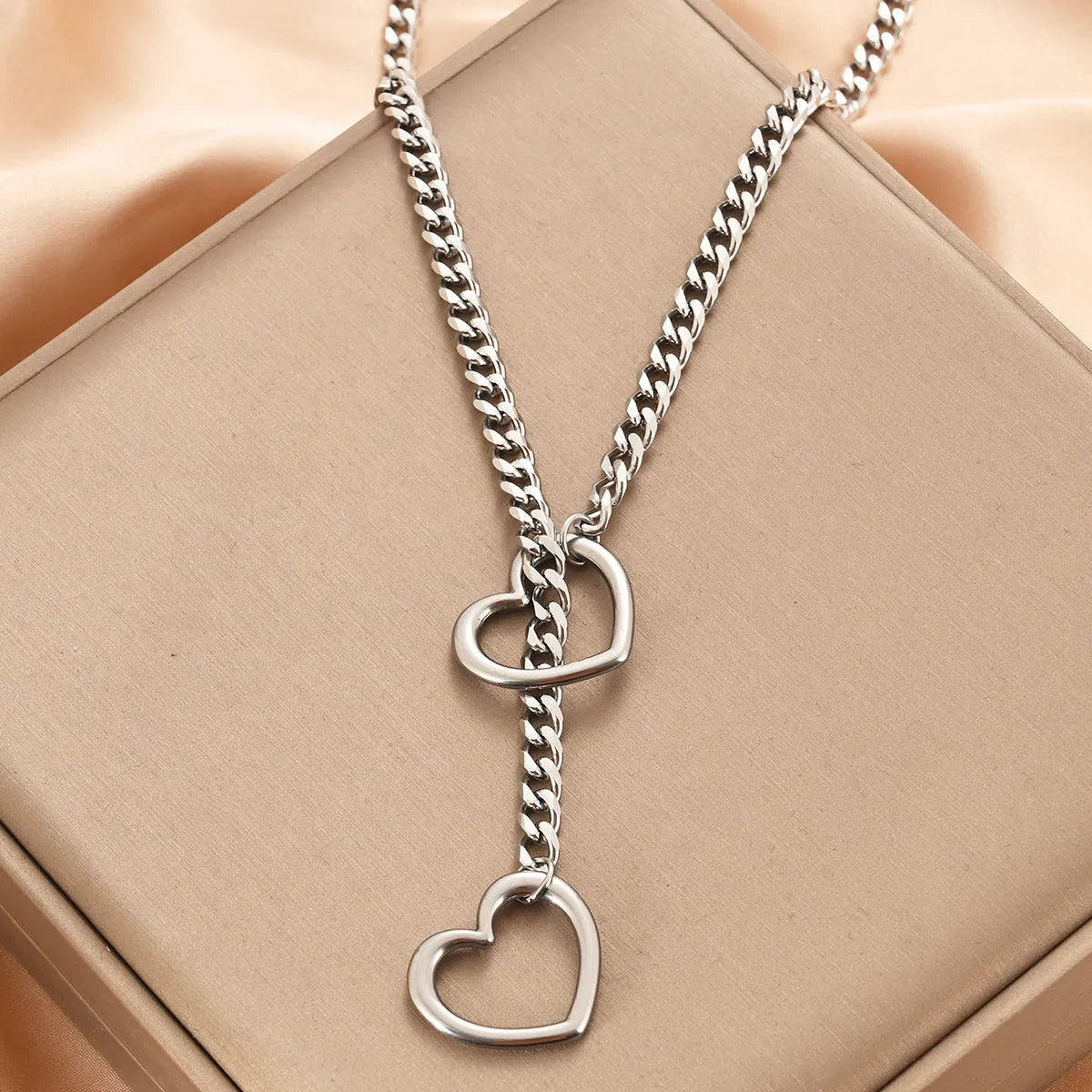 Stainless steel lariat heart necklace with long regular chain in steel, gun black, or gold