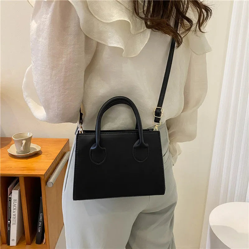 Women's black PU leather horizontal square shoulder bag with single strap and sewing line detailing