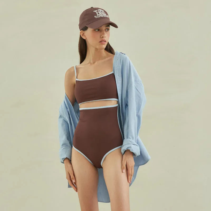 Brown women's triangle top one-piece swimsuit on hanger showing front design
