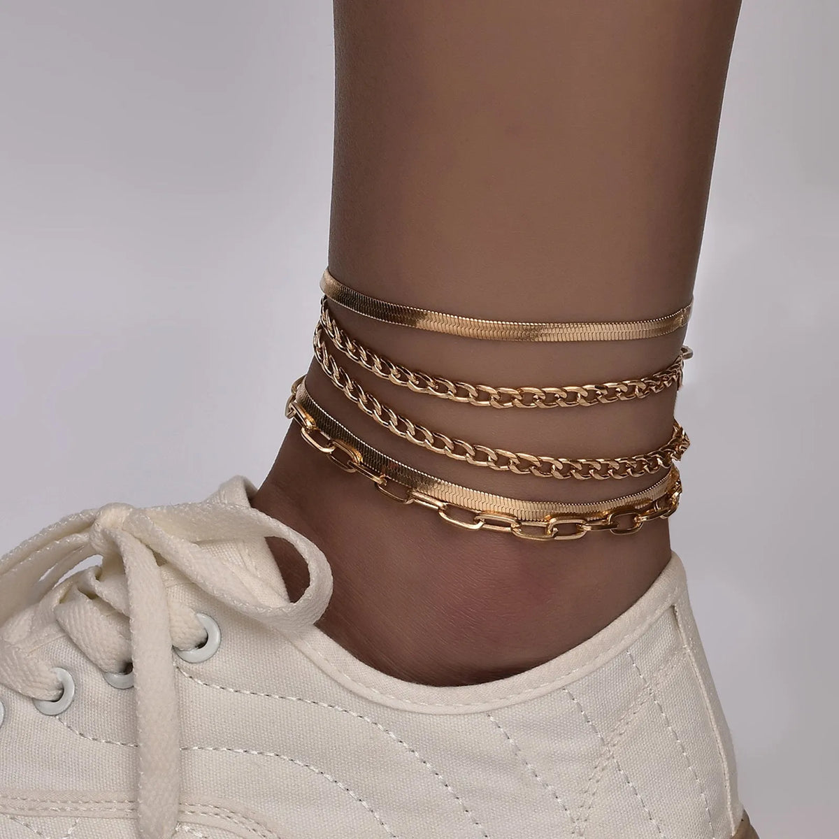 Women's multi-layer metal chain anklet set in gold and silver colour options on display