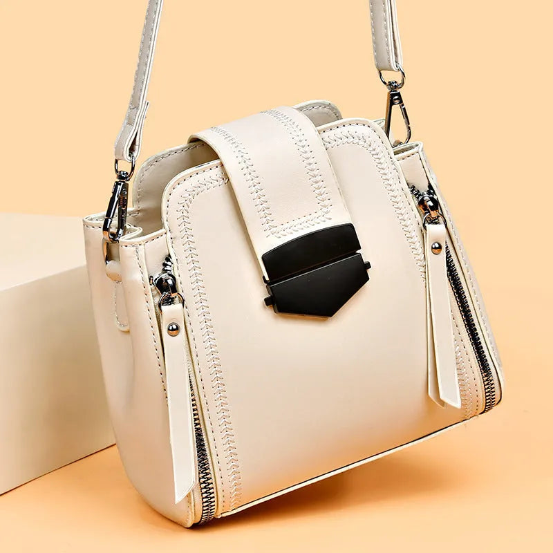 Small square vertical handbag in soft PU leather with textured stitching, shown in multiple colour options.