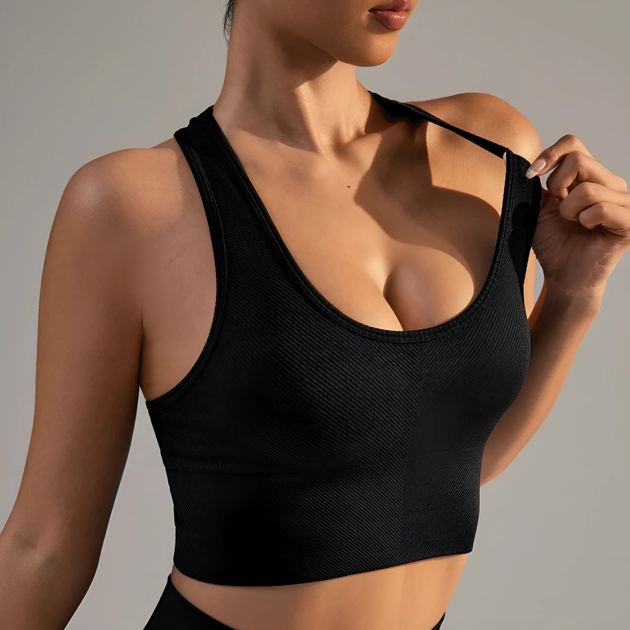 Black cross-back sports bra with quick-dry nylon fabric for running and yoga support
