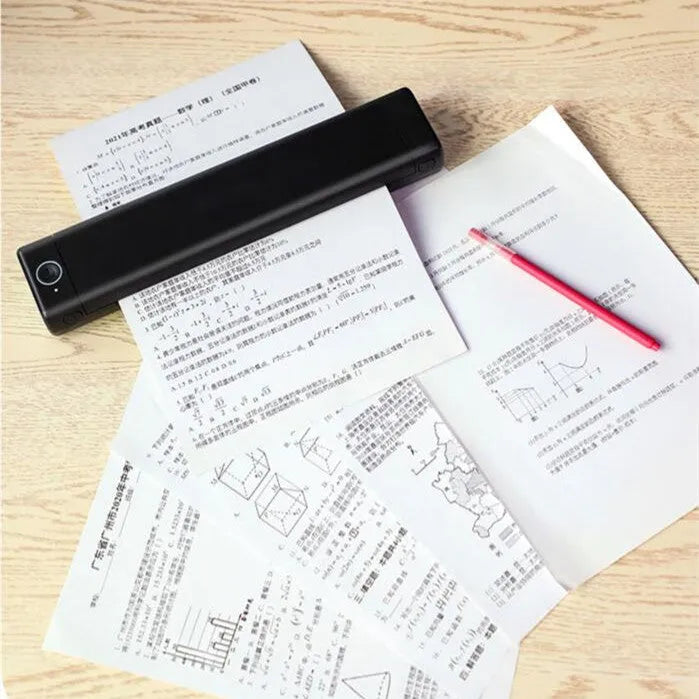 Phomemo M08F white portable A4 thermal printer on a desk next to a mobile phone.