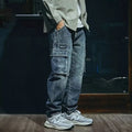 Man wearing blue loose straight-leg retro jeans with a zip fly, showcasing the casual fit.