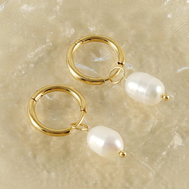 Gold geometric women's drop earrings with a pearl centre on hypoallergenic titanium steel posts.