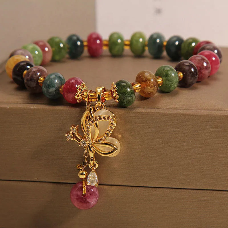 Colourful women's bracelet with butterfly charm and bead accents on alloy band