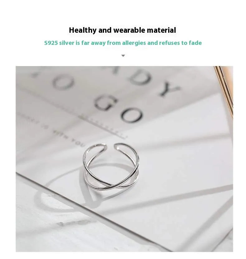 Silver geometric cross ring with adjustable opening on female hand