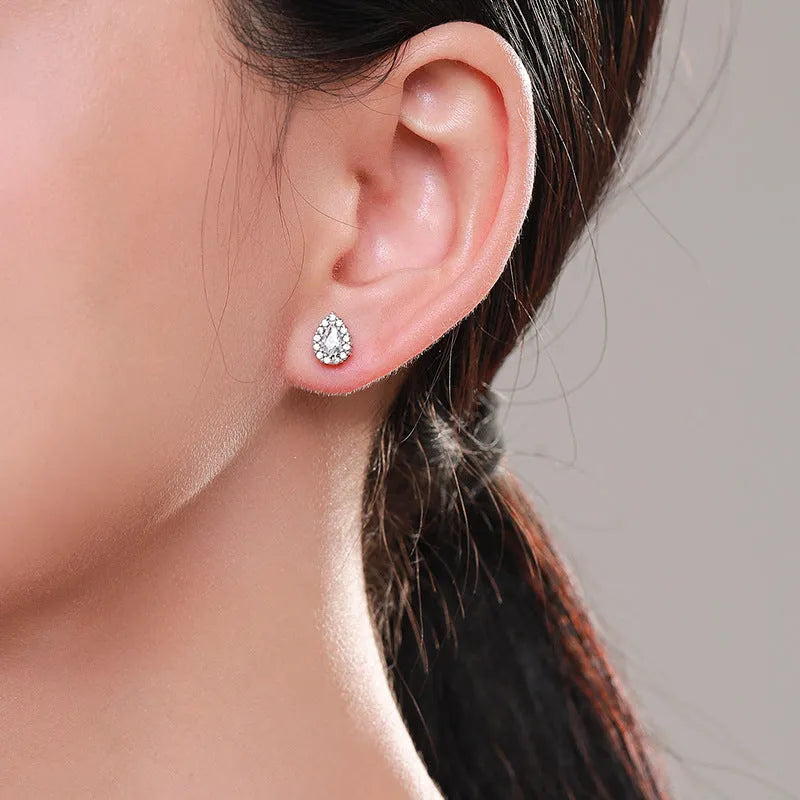 Women's silver water drop shaped ear studs made from 925 sterling silver with diamond treatment