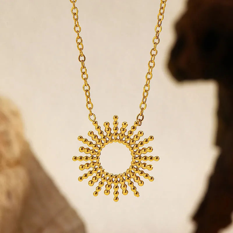 Gold-colour sunflower series necklace and bracelet set with geometric chain on a white background.