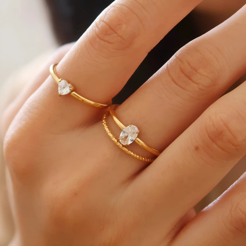Golden electroplated stainless steel heart ring with oval design elements in women's sizes 5-8
