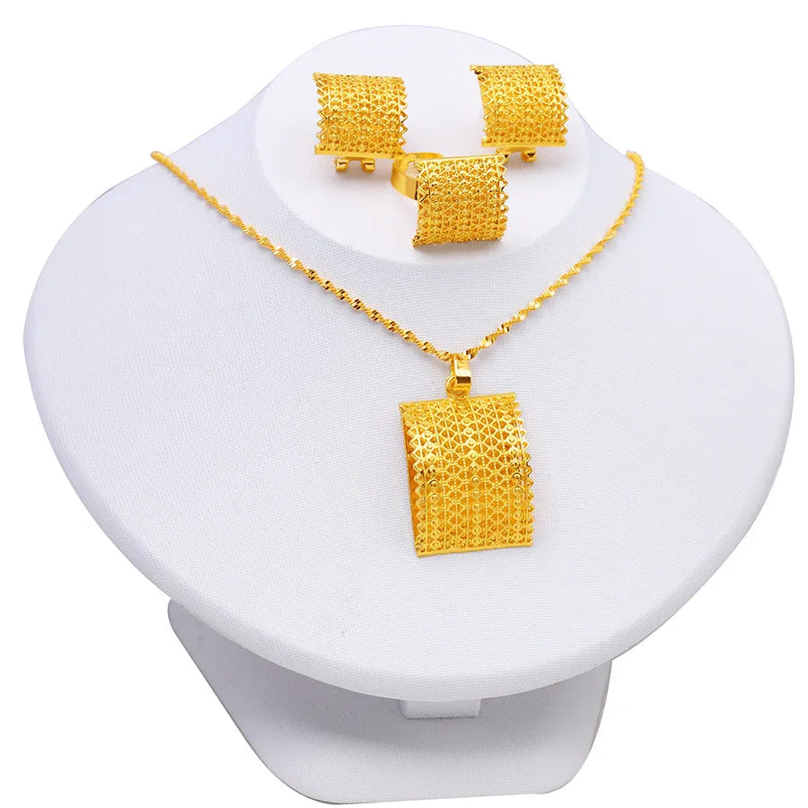 Golden copper bridal jewellery set showing necklace, earrings, and ring on a display.