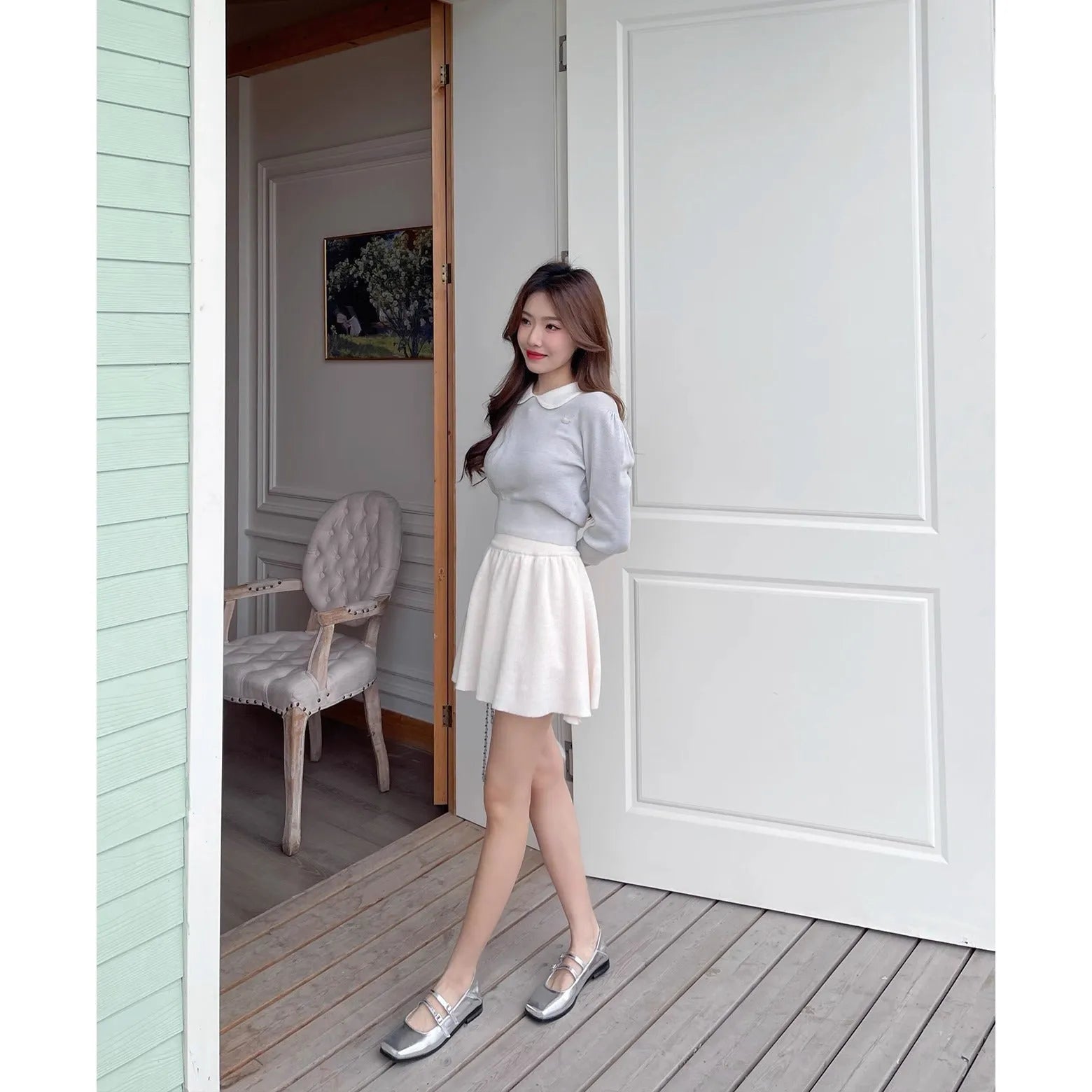 Women's silver leather Mary Jane flats with a cross-buckle ankle strap and round toe.