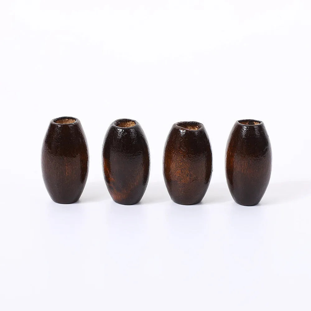 Dark coffee coloured wooden oval bead with M-shaped raised design, 25mm size