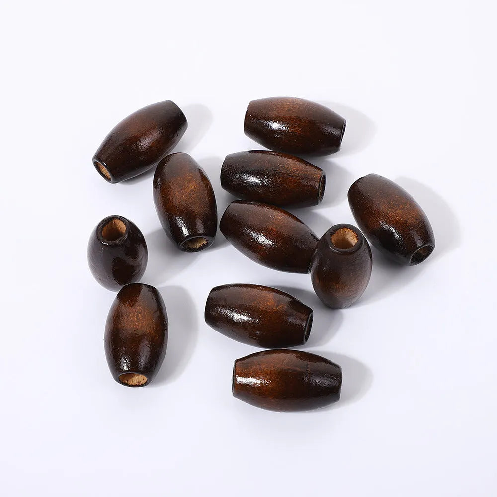 Dark coffee coloured wooden oval bead with M-shaped raised design, 25mm size
