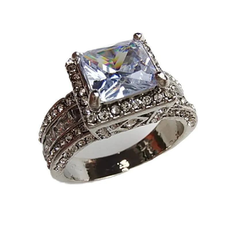 Geometric silver-toned women's ring with a round design element on a hand.