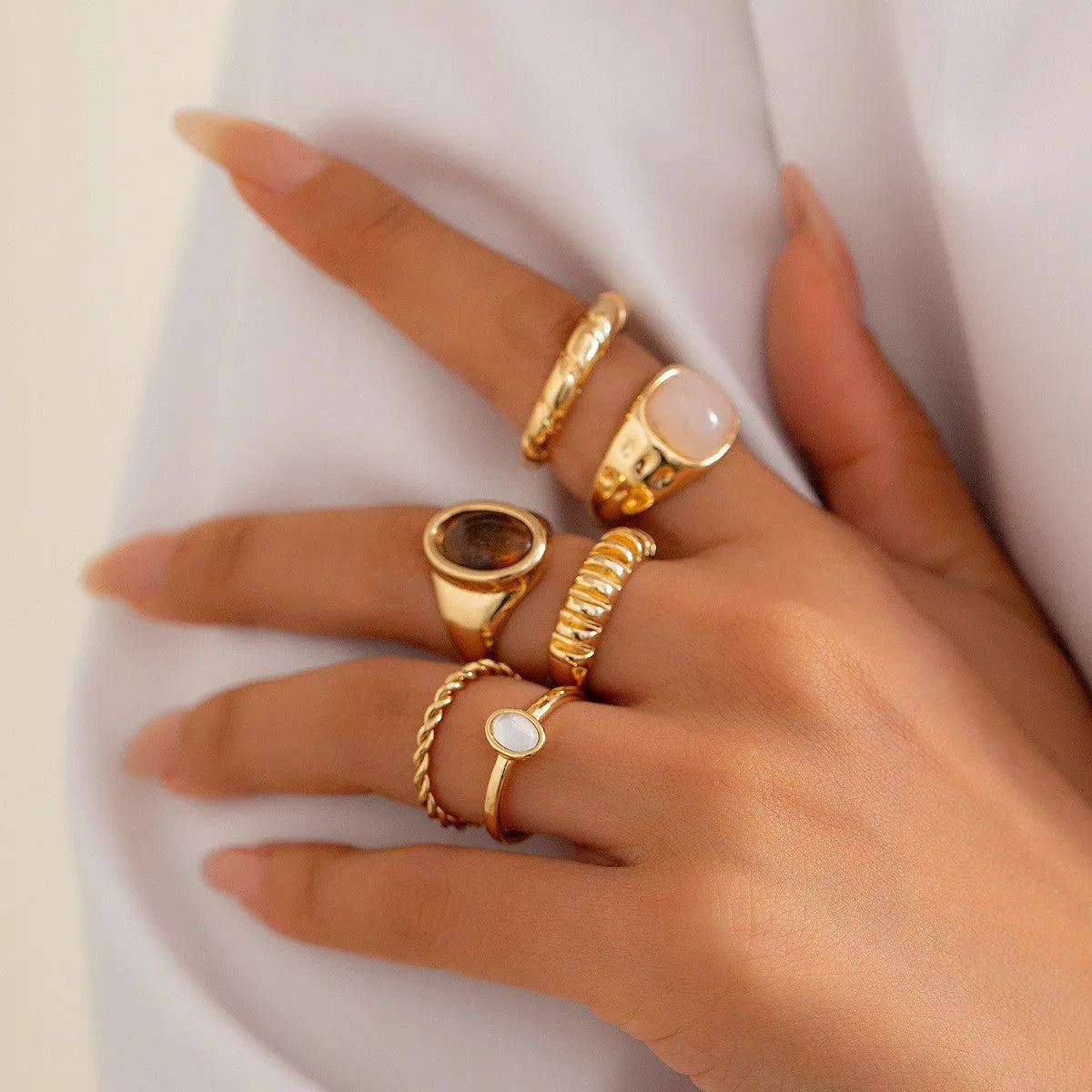 Set of six light gold geometric and round alloy rings with electroplated finish