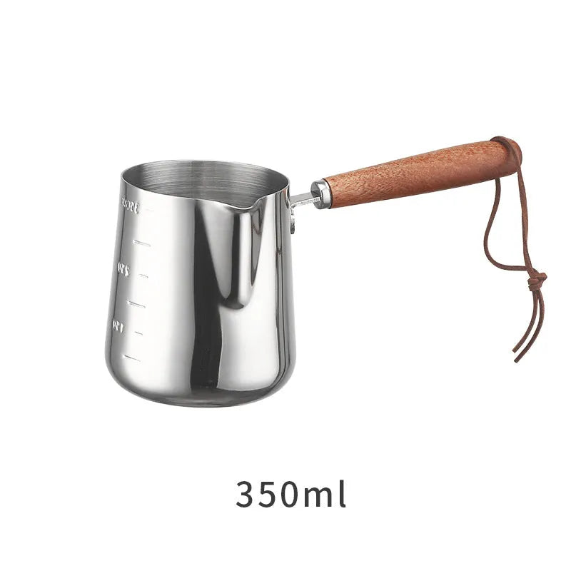Stainless steel coffee milk jug with a scaled wooden handle shown in a simple solid colour.