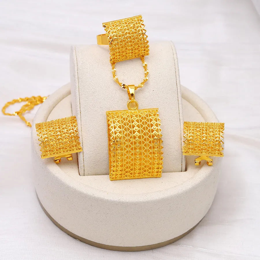 Golden copper bridal jewellery set showing necklace, earrings, and ring on a display.