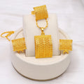 Golden copper bridal jewellery set showing necklace, earrings, and ring on a display.