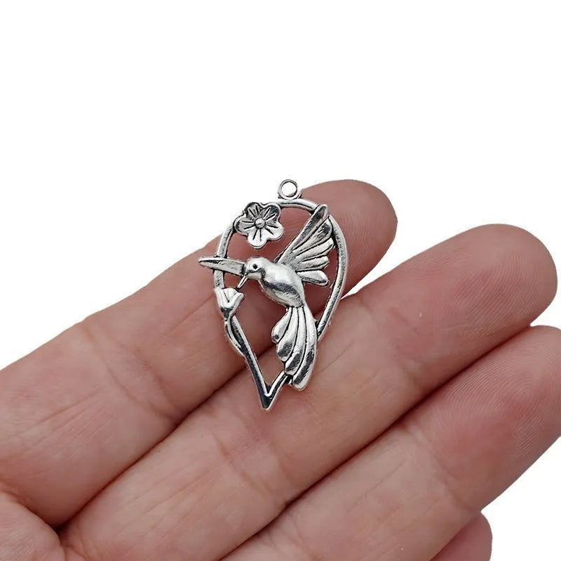 Close-up of a detailed alloy cuckoo bird charm pendant with electroplated finish in colour P234.
