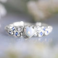 White alloy women's ring with a heart shape and floral opal ocean design details.