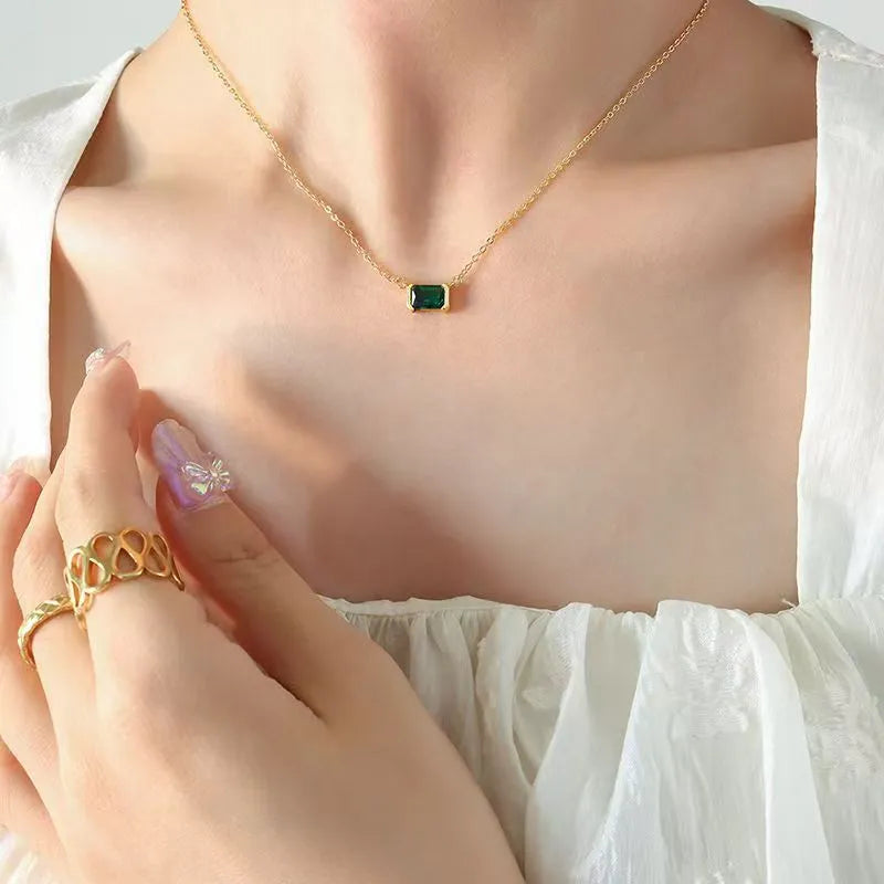 Gold geometric pendant necklace with a square Lvzuan stone inlay on a chain