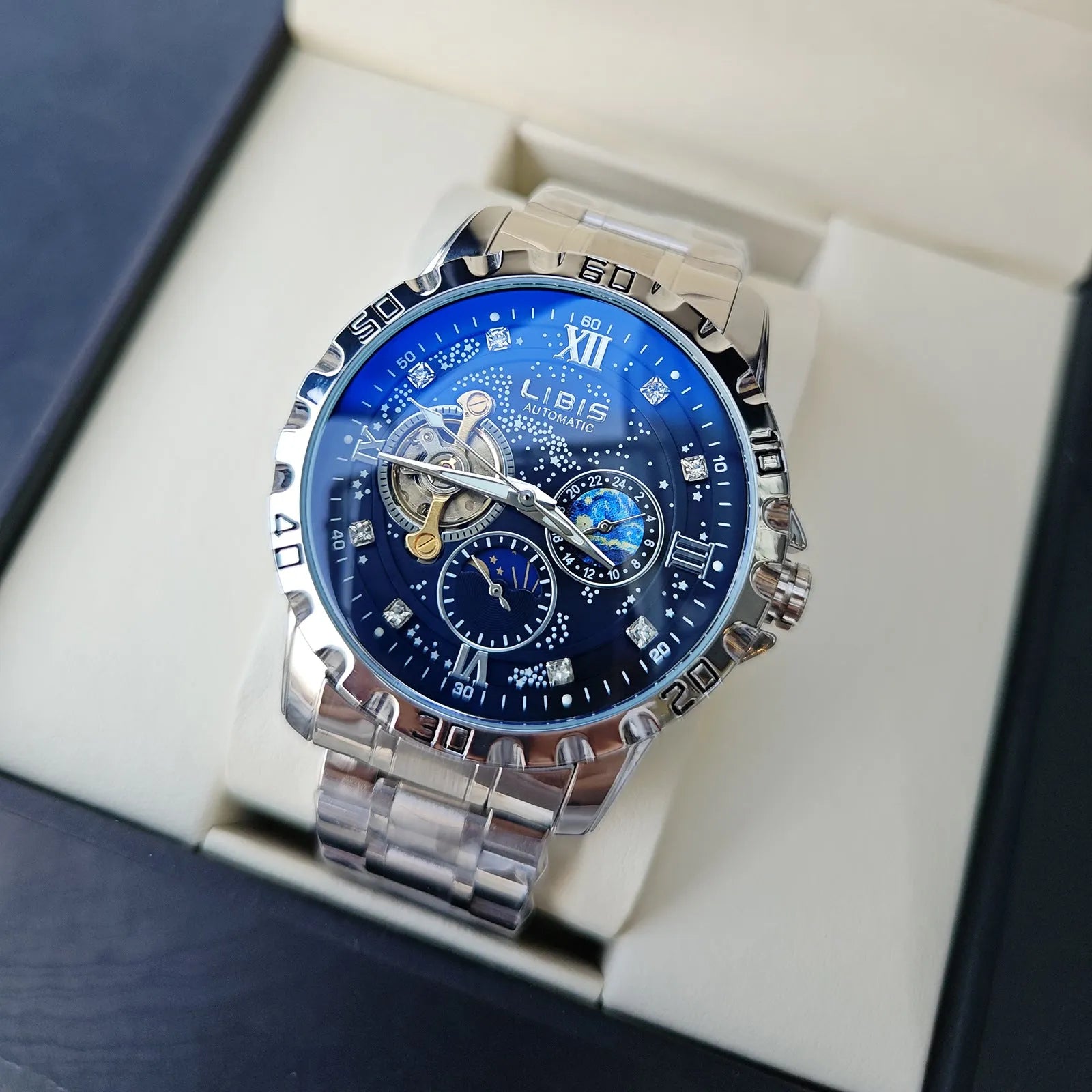 Men's silver automatic watch with black starry luminous dial on a leather strap.