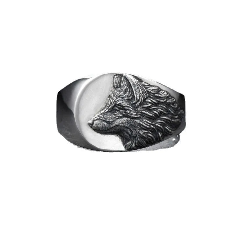 Silver men's ring with a geometric wolf design on a black background.