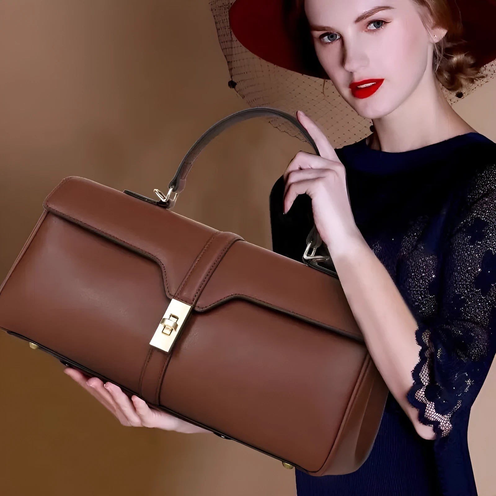 Women's cylindrical leather messenger bag in black with internal organiser pockets