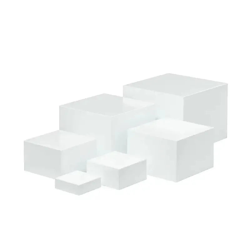 Set of six white plastic tiered dessert display stands arranged on a table.