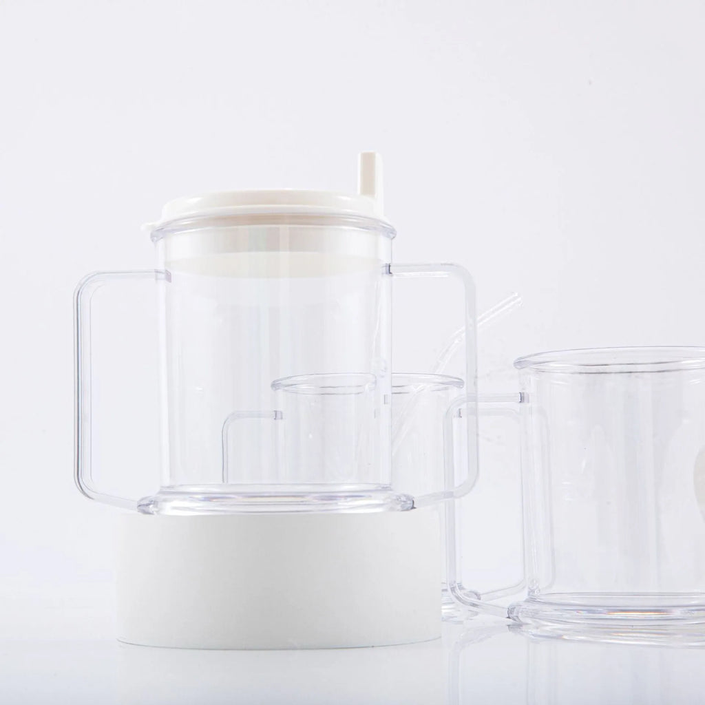 Transparent plastic drinking cup with a grey spill-proof lid on a white background.