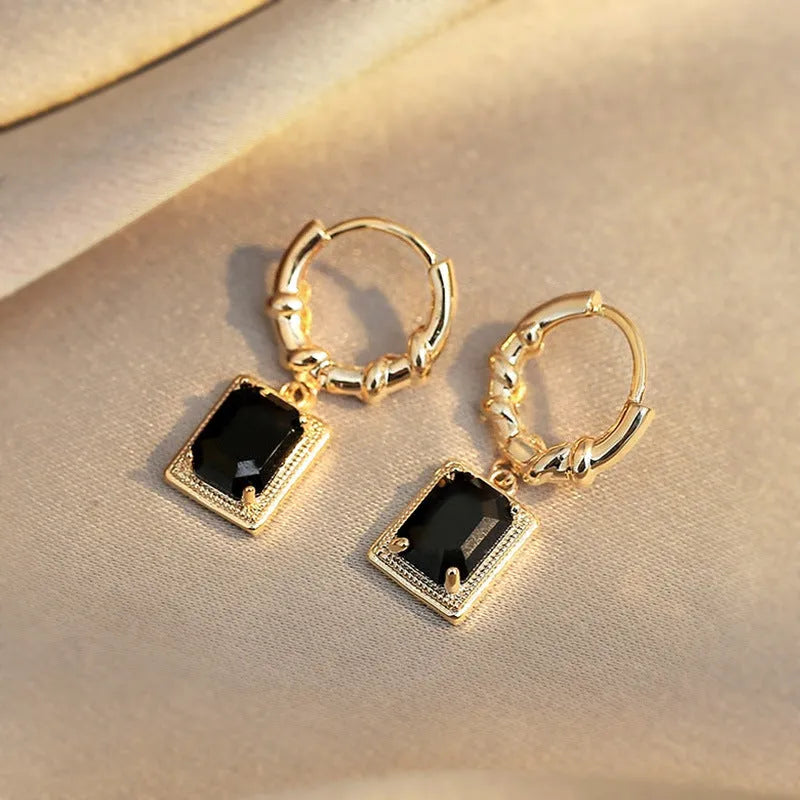 A pair of geometric black quadrilateral copper earrings with a zircon stone in a retro French court style.