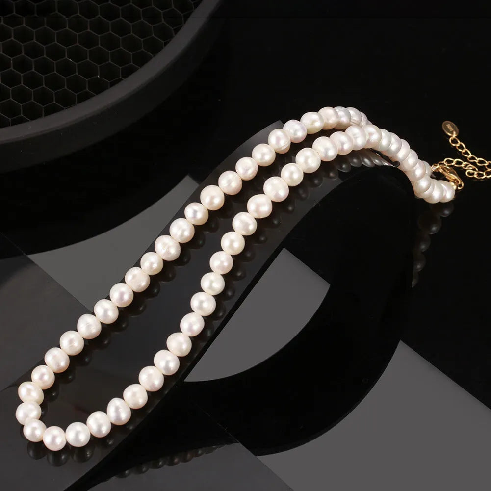 Women's silver necklace with round natural freshwater pearls on an adjustable chain.