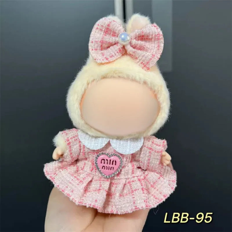 Plastic clothing costume for a 17cm tall vinyl doll figurine on display.