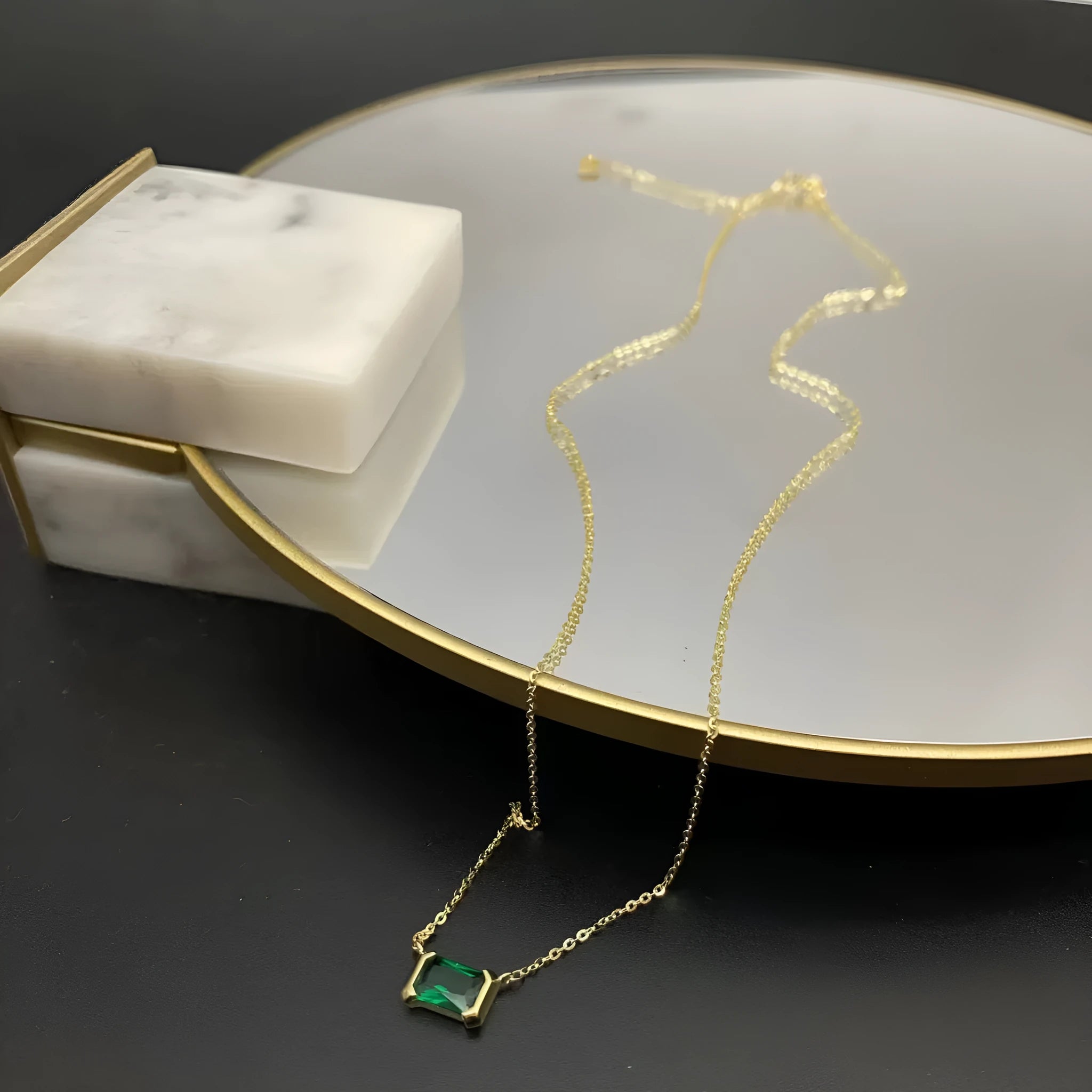 Gold geometric pendant necklace with a square Lvzuan stone inlay on a chain