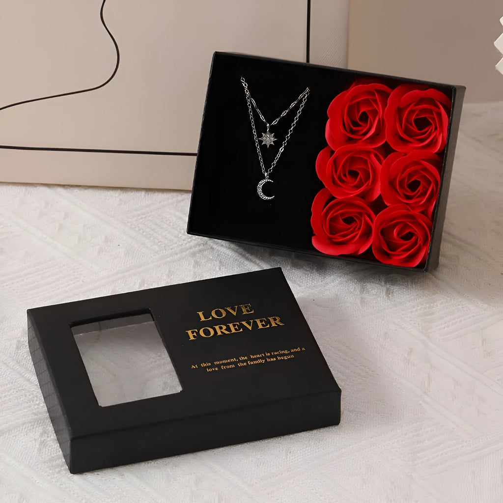 Red Korean-style gift box open to show six pink soap flowers, with a matching handbag beside it.