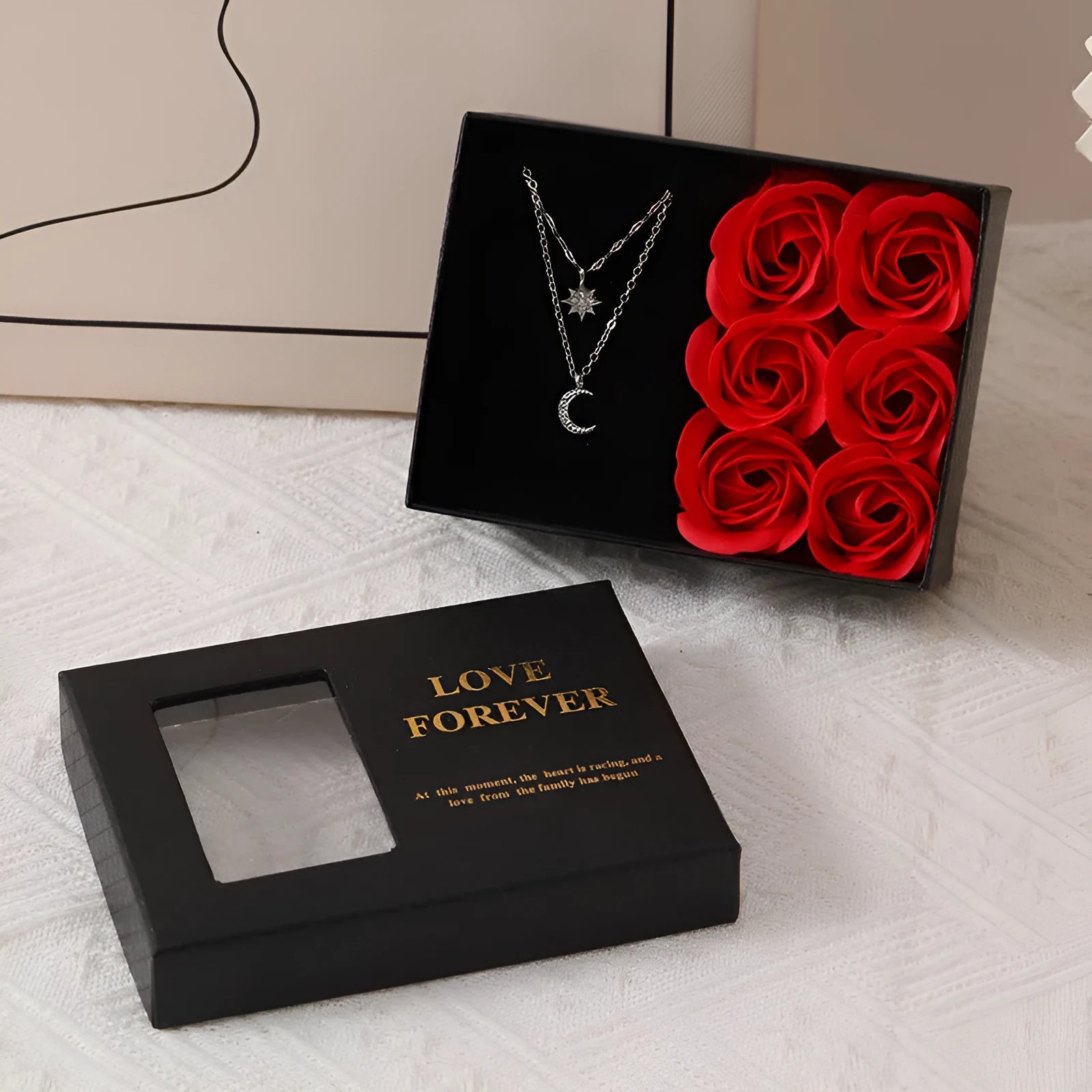 Red Korean-style gift box open to show six pink soap flowers, with a matching handbag beside it.