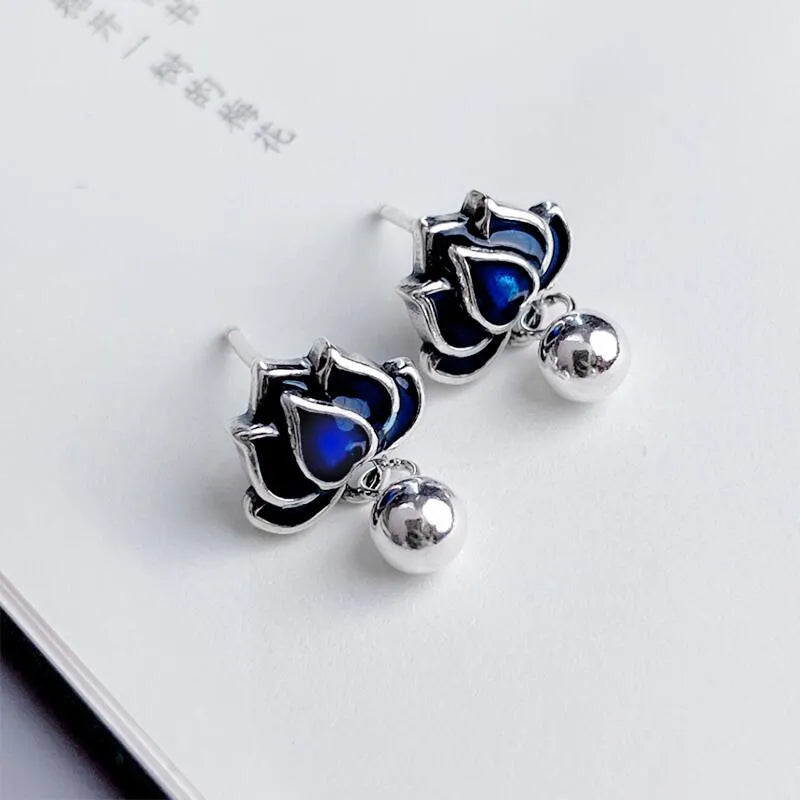 Blue lotus seedpod tassel ear studs with floral design on silver needle fittings