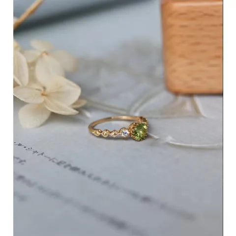 Copper geometric ring with quadrilateral design on a wooden background.
