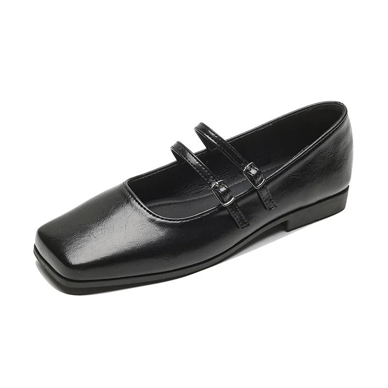 Women's silver leather Mary Jane flats with a cross-buckle ankle strap and round toe.