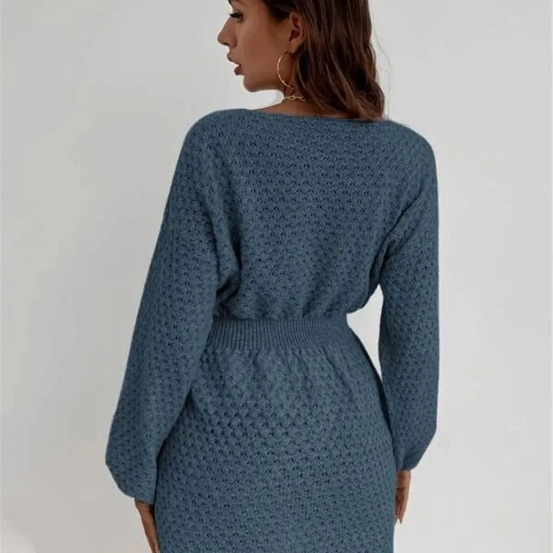 Blue women's knitted dress with crocheted flower details, round neck, fitted waist, and long sleeves.