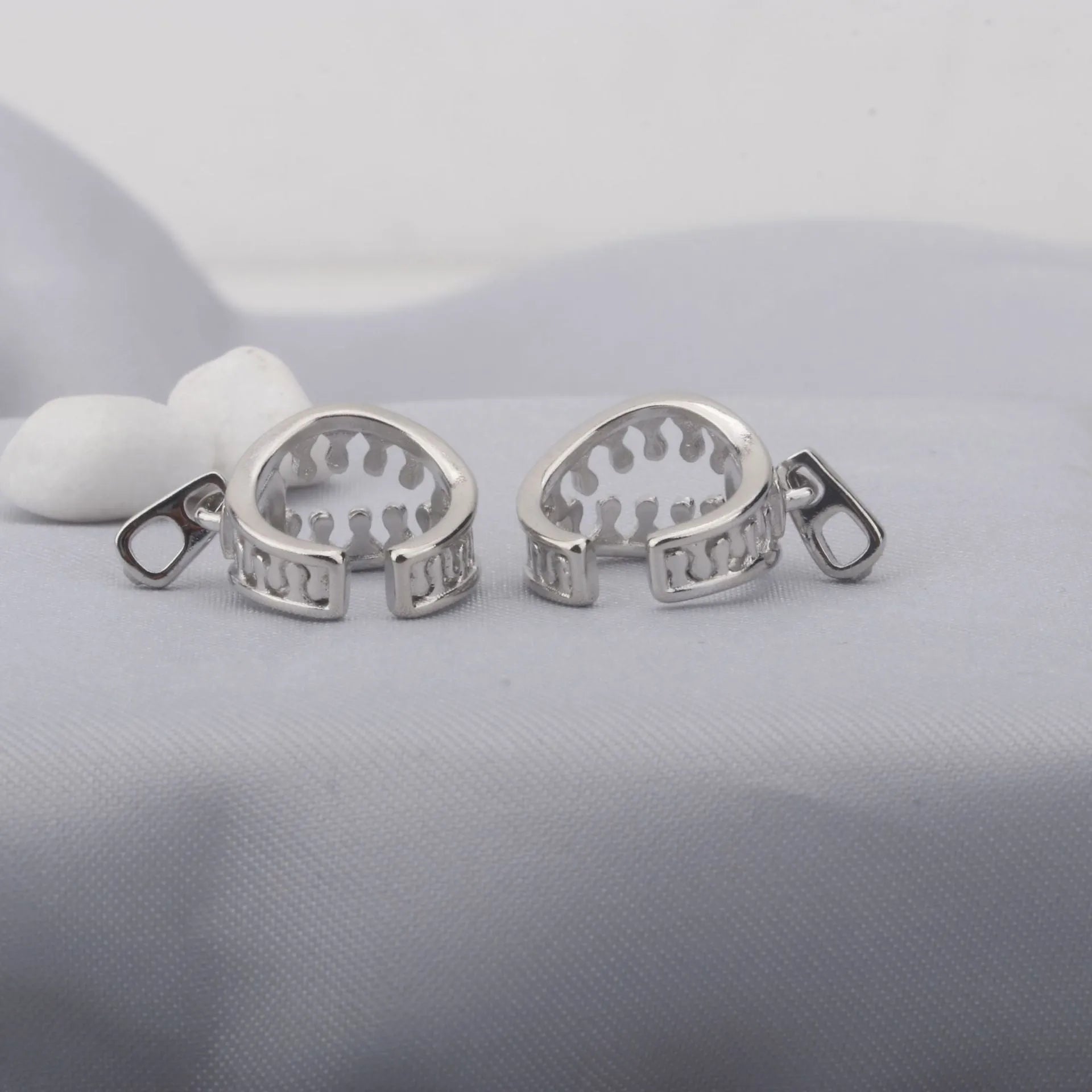 A pair of geometric copper clip-on earrings with linear design in ES862 colour.
