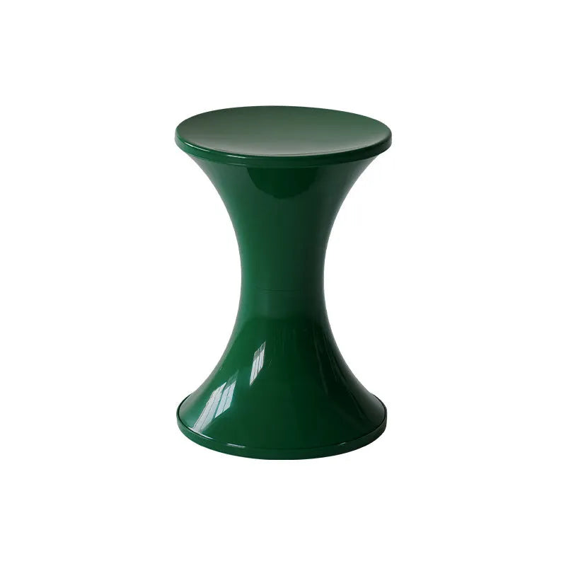 A white hourglass-shaped plastic shoe changing stool on a wooden floor.