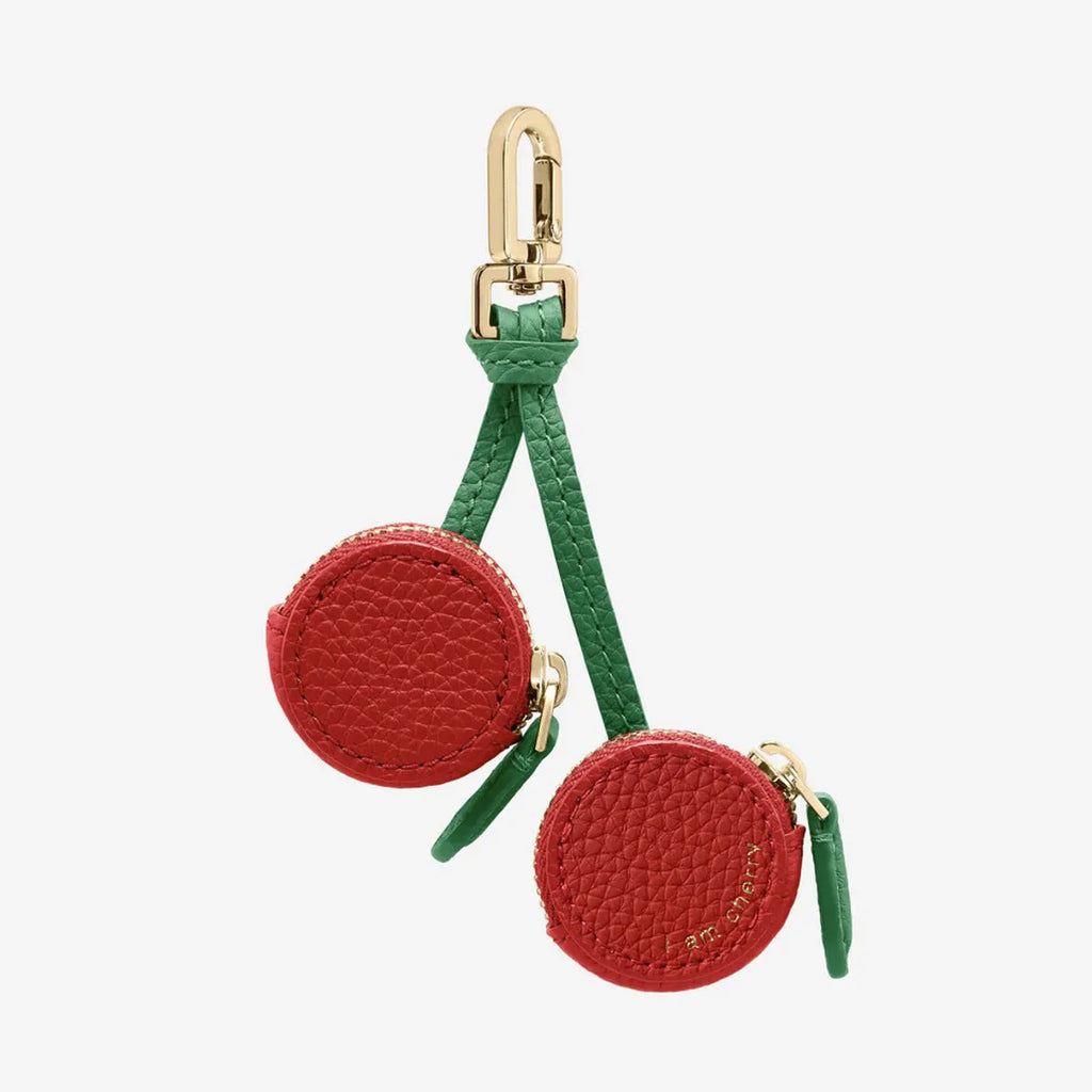 Solid colour leather keychain with small attached coin pouch in cherry red, blueberry blue, or orange.
