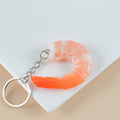 PVC simulation shrimp-shaped novelty keychain with door buckle, shown in modern simplicity style.