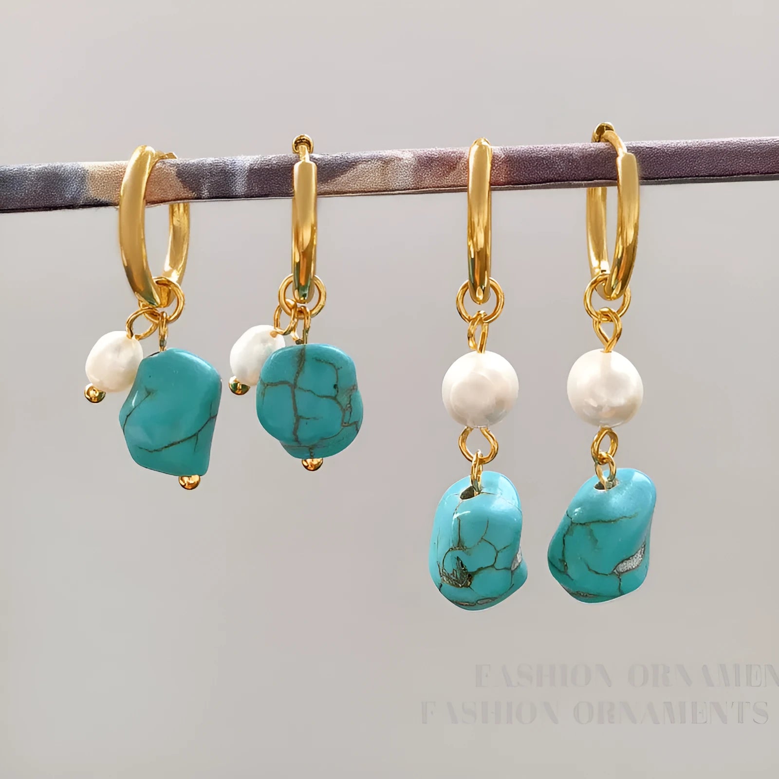 A pair of geometric copper ear clips with irregular turquoise stone and cultured pearls, showing both short and dangle styles.