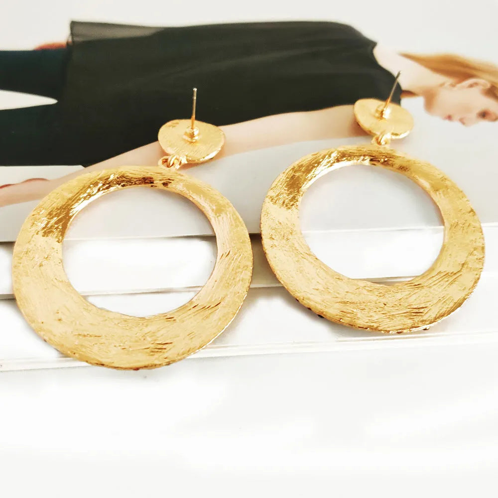 A pair of large colourful alloy pendant earrings with a diamond-shaped round cartoon design.