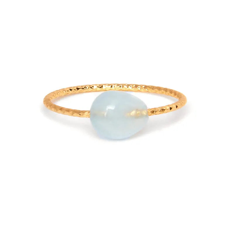 Geometric silver-tone ring with a coloured agate stone in a niche design, side view.