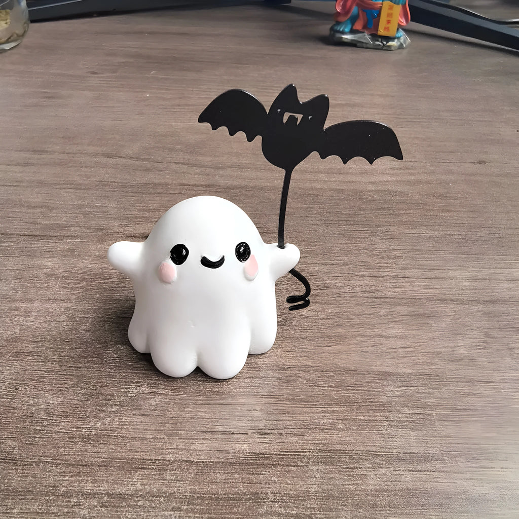 Miniature ghost walking dog statue holding a bat, a small resin Halloween ornament.