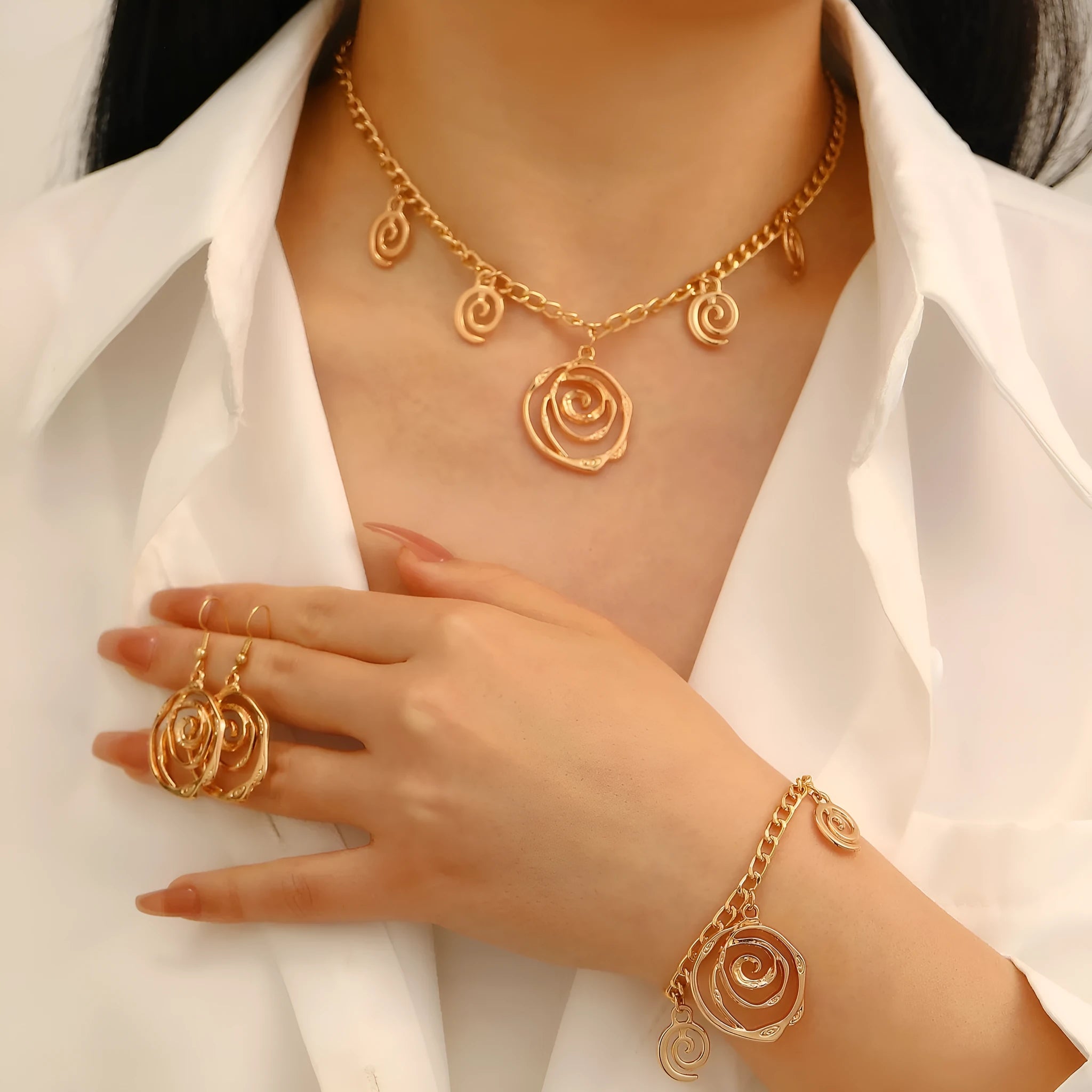 Spiral donut jewellery set showing necklace, bracelet, and ear hooks in gold or silver tone alloy